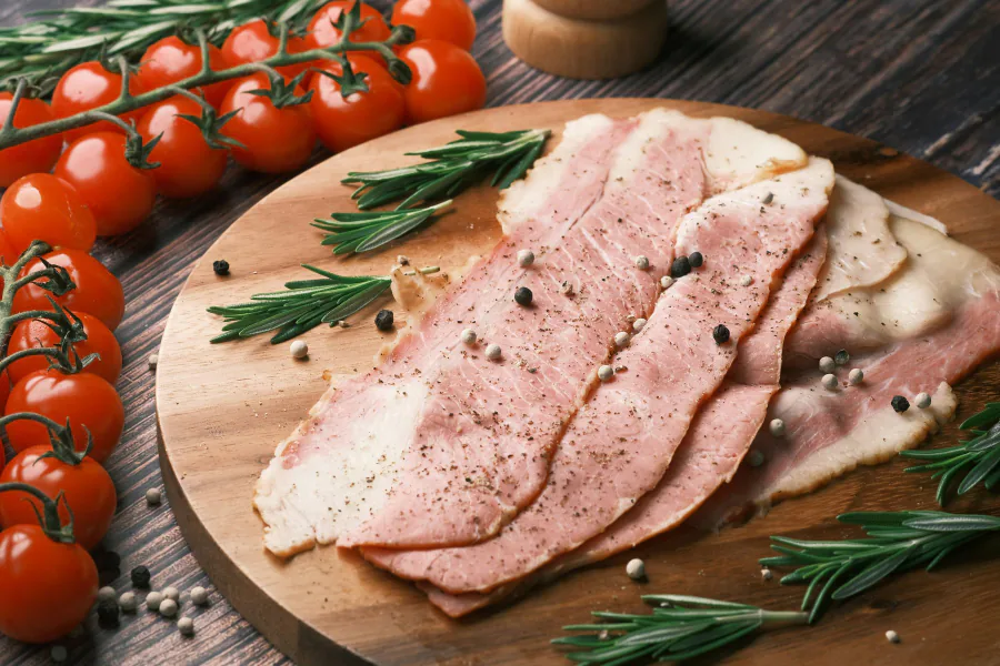 Slices of smoked bacon on a wooden board